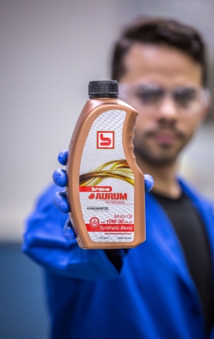 man holding brava aurum product bottle